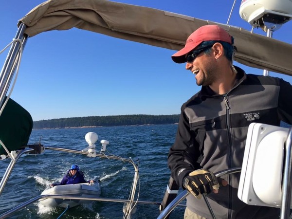 Gabriel driving the boat while Chestnut rides in the dingy