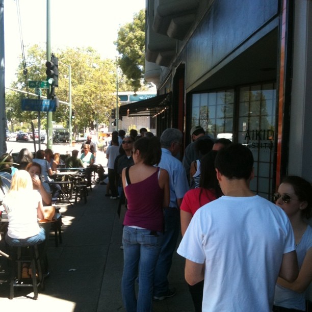 Waiting in line for a delicious sandwich.